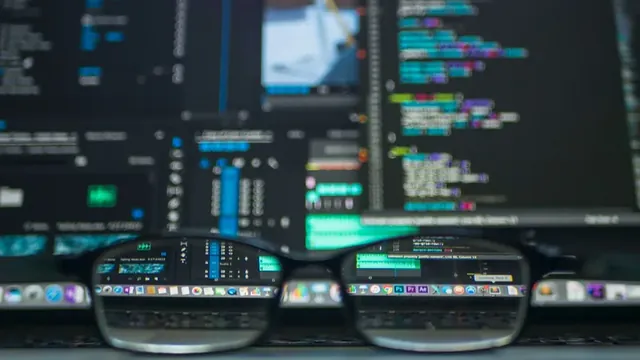 Glasses in front of a screen showing source code during a security review