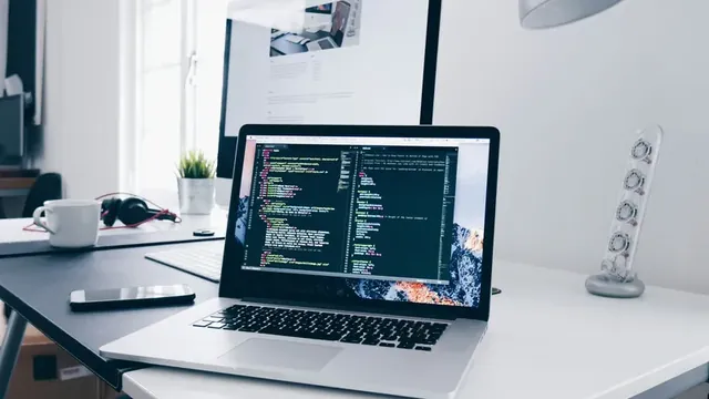 Laptop with source code on a desk